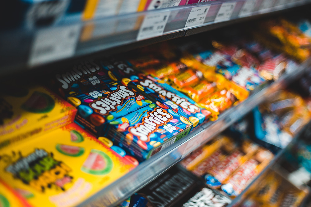 candy and gum neatly organized in the checkout aisle of a supermarket