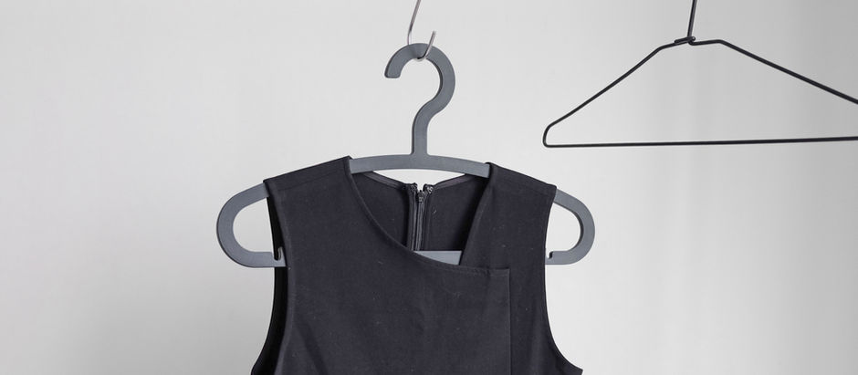 a black dress on a hanger on a rack