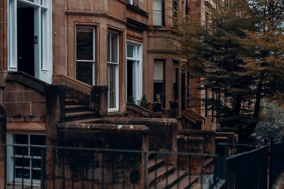 Brown sandstone tenements with steps leading up to the door and railings outside