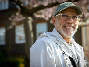 Smiling older man in a cap and glasses