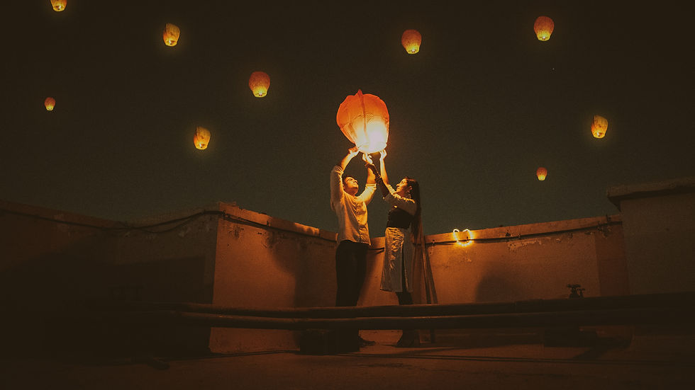 a couple releasing a floating lantern