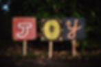 a yard sign that says "JOY'