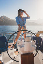 Image woman at the helm driving a boat