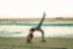 Woman doing yoga on the beach