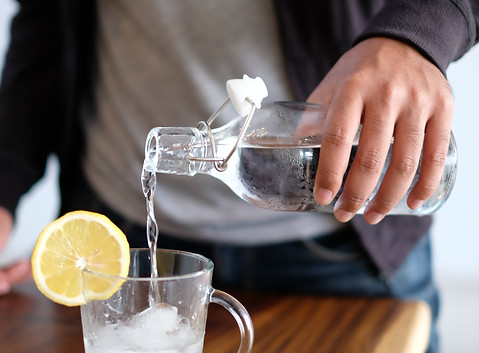 Man pours water into a glass