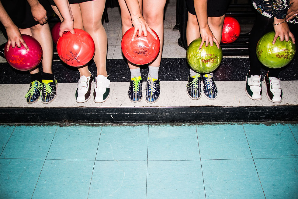 People holding bowling balls