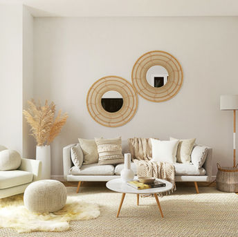 Modern living room with neutral tones and round mirrors
