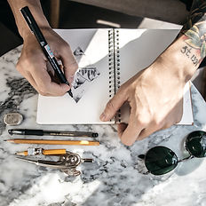 flatlay of sketches with pencils and paper
