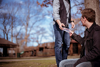 A guy handing a person a ticket