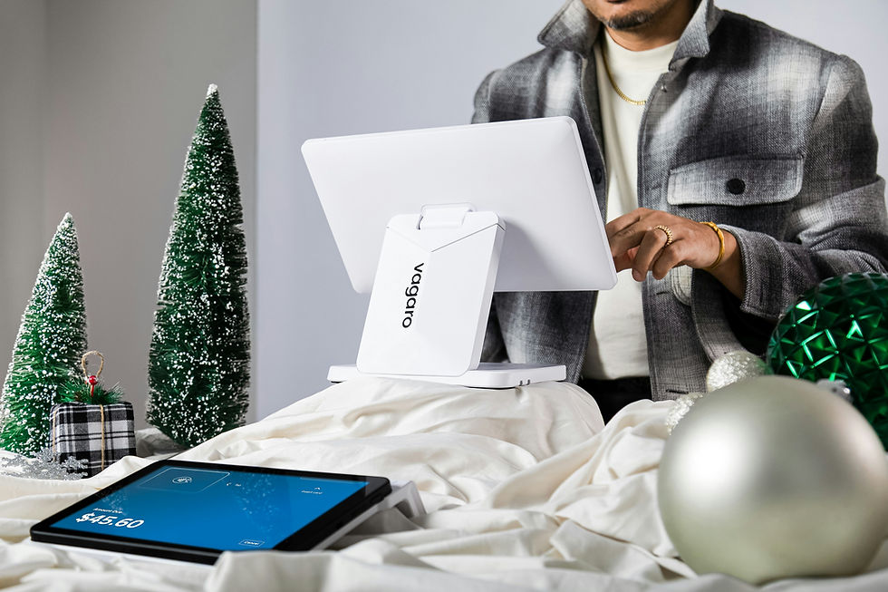 Man using VOGOGO POS system, tablet shows $45.00, holiday decor.