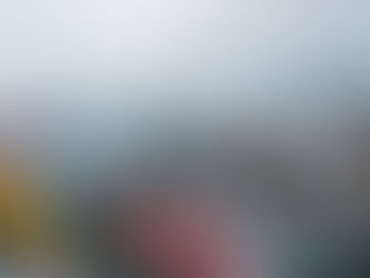 Snow-covered mountain roads winding through Ladakh, with colorful prayer flags overlooking a dramatic high-altitude Himalayan landscape.