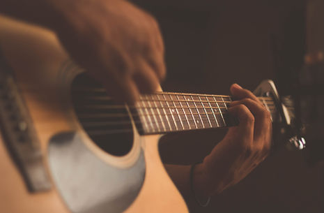 Young man taking guitar lessons