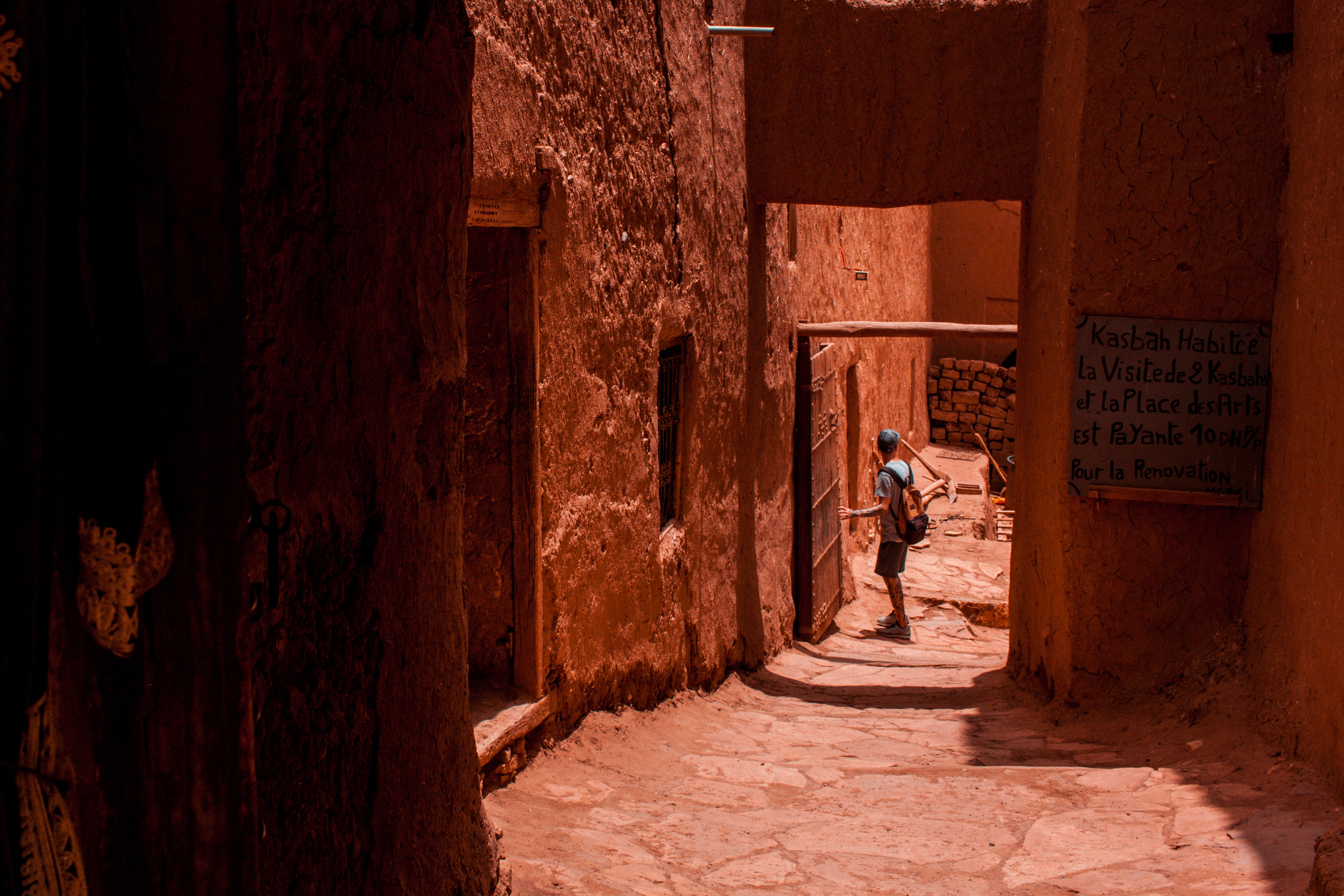 High angle view of a narrow Moroccan medina alley with colorful textiles