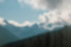 Clouds in the distance clearing to show beautiful mountains