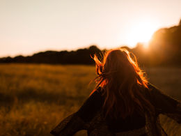 A woman's silhouette against a sunset 