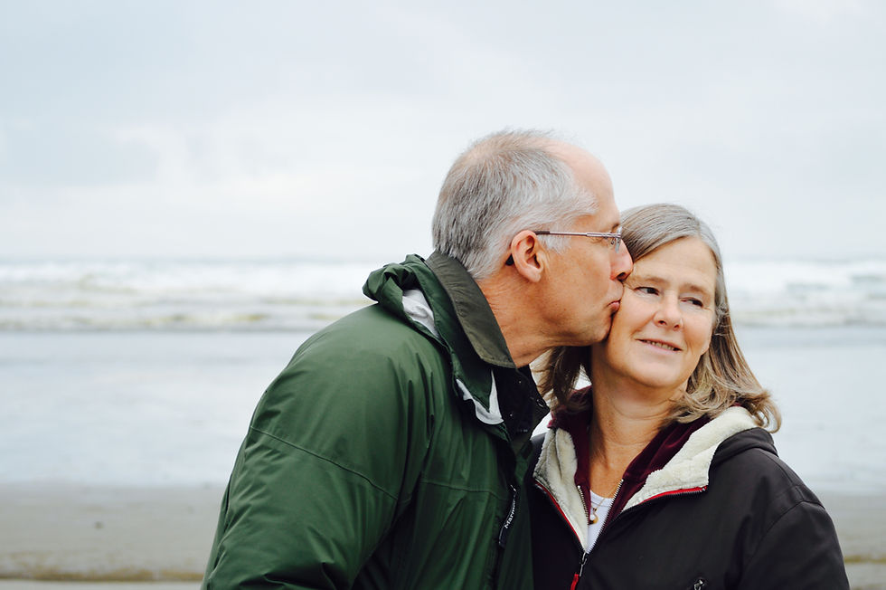 An older couple in a moment of joy, with the man kissing the woman's cheek, embodying happiness and vitality in aging.