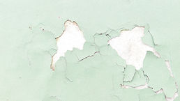 Broken paint chips due to moisture build up due to leaking roof