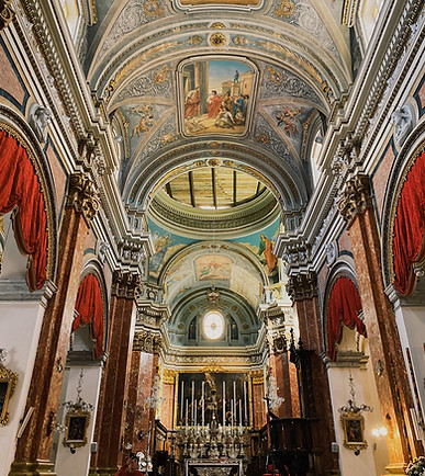 The opulent Baroque interior of St. John’s Co-Cathedral, adorned with intricate carvings and gold detailing