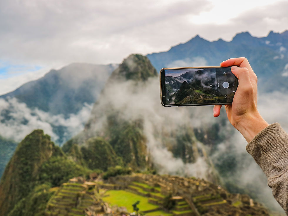 Smartphone capturing a photo of Machu Picchu with mountain views in the background