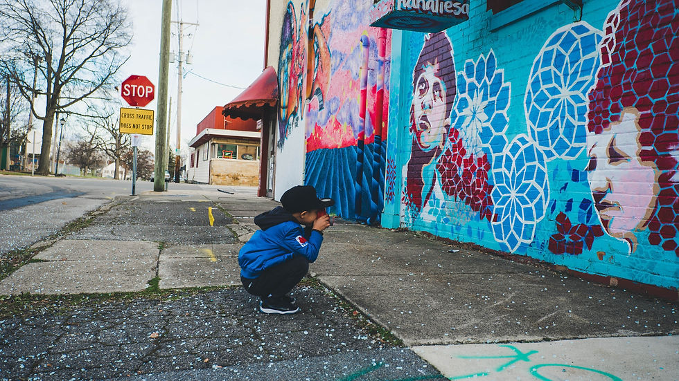 creatively gifted child taking a picture of mural