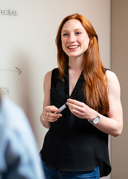 Young professional woman presenting to colleague
