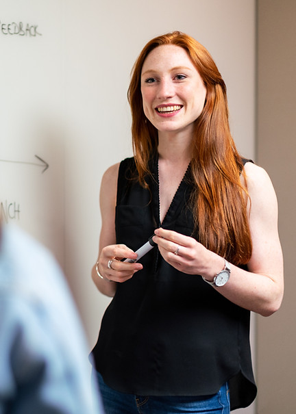 Young professional woman presenting to colleague
