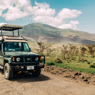 Safari vehicle driving in Ngorongoro highlands during a 4 day safari from Zanzibar Tanzania