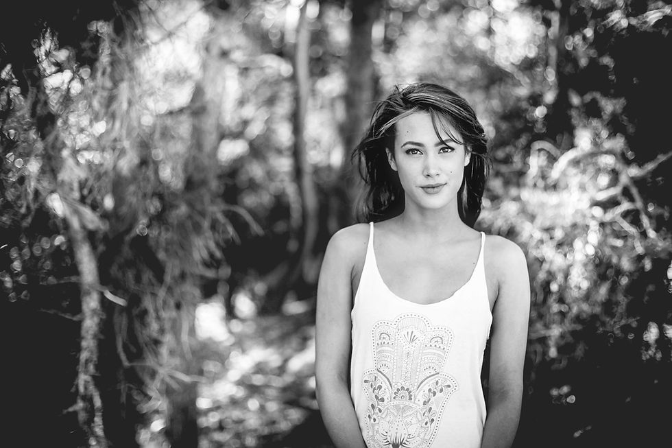 Black and white portrait of female model stood outdoors with bokeh