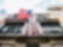 Downtown building framing an American flag - Image by Patrick Tomasso