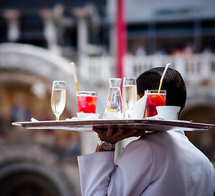 Man holding drinks to serve customers