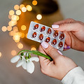 woman holding pack of supplements to depict nutrient deficiencies