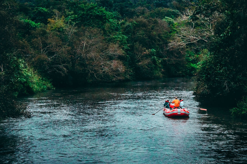 People looking downstream in a whitewater raft