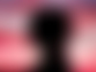 A young girl's silhouette framed against a pink sunset.