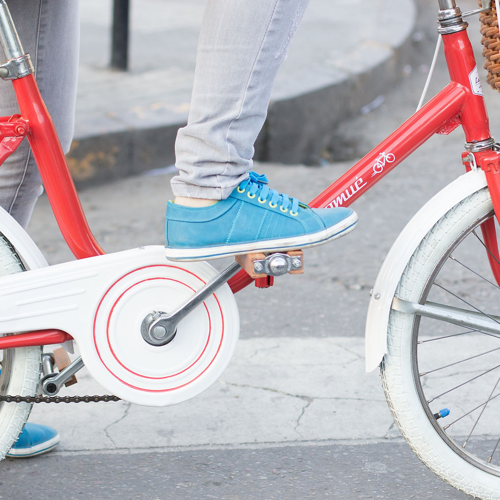 Woman in blue trainers on red bike