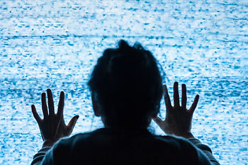older woman with hands on tv screen static showing depicting alzheimers, memory loss