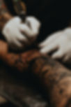 Tattooist working on an arm