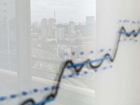 A graph with an upward trend and city in background