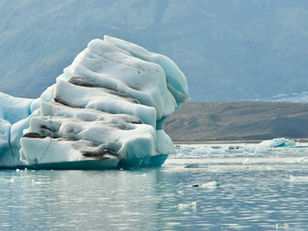 Iceberg slowly eroding in the water, representing how small accounting errors compound over time.