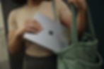 A person carefully places a Windows laptop into a bag, symbolizing the importance of securing business devices after implementing critical updates like those from Microsoft Patch Tuesday.