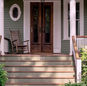 Beautiful front door with greenery, fresh paint, and clear entry path