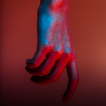 a finger pointing downwards red and blue