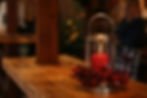 A red candle on a rustic wooden countertop