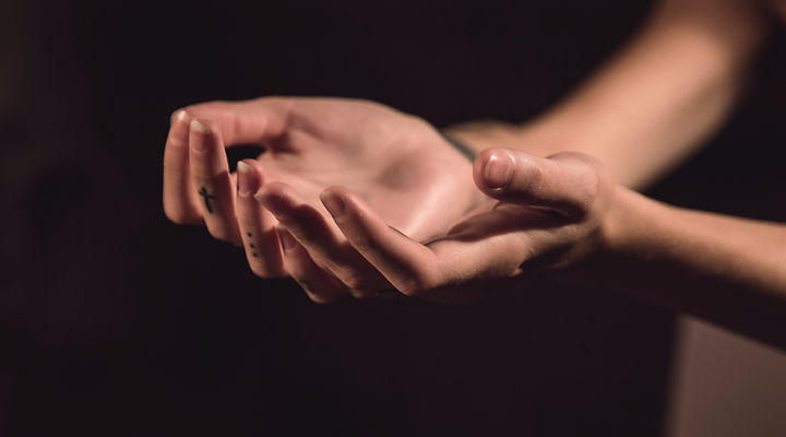 Hands in upward position preparing for Reiki healing.