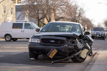Image by Michael Jin. Car with damage to front end.