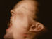 A man looking pained and turning his face, as though slapped.