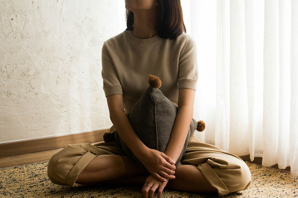 A woman sitting and pondering.