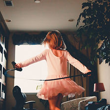 A little girl twirling in a ballerina costume.