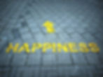 HAPPINESS & arrow sprayed in yellow on bricks