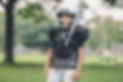 boy wearing American football gear