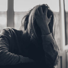 A woman holding her head in her hand